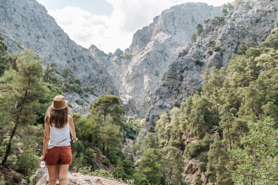 Woman enjoying nature on a hike with stunning mountain views.