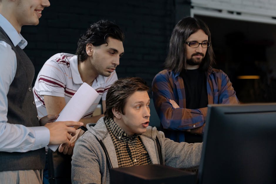 A diverse group of adults working together in a modern office environment, showcasing teamwork and collaboration.